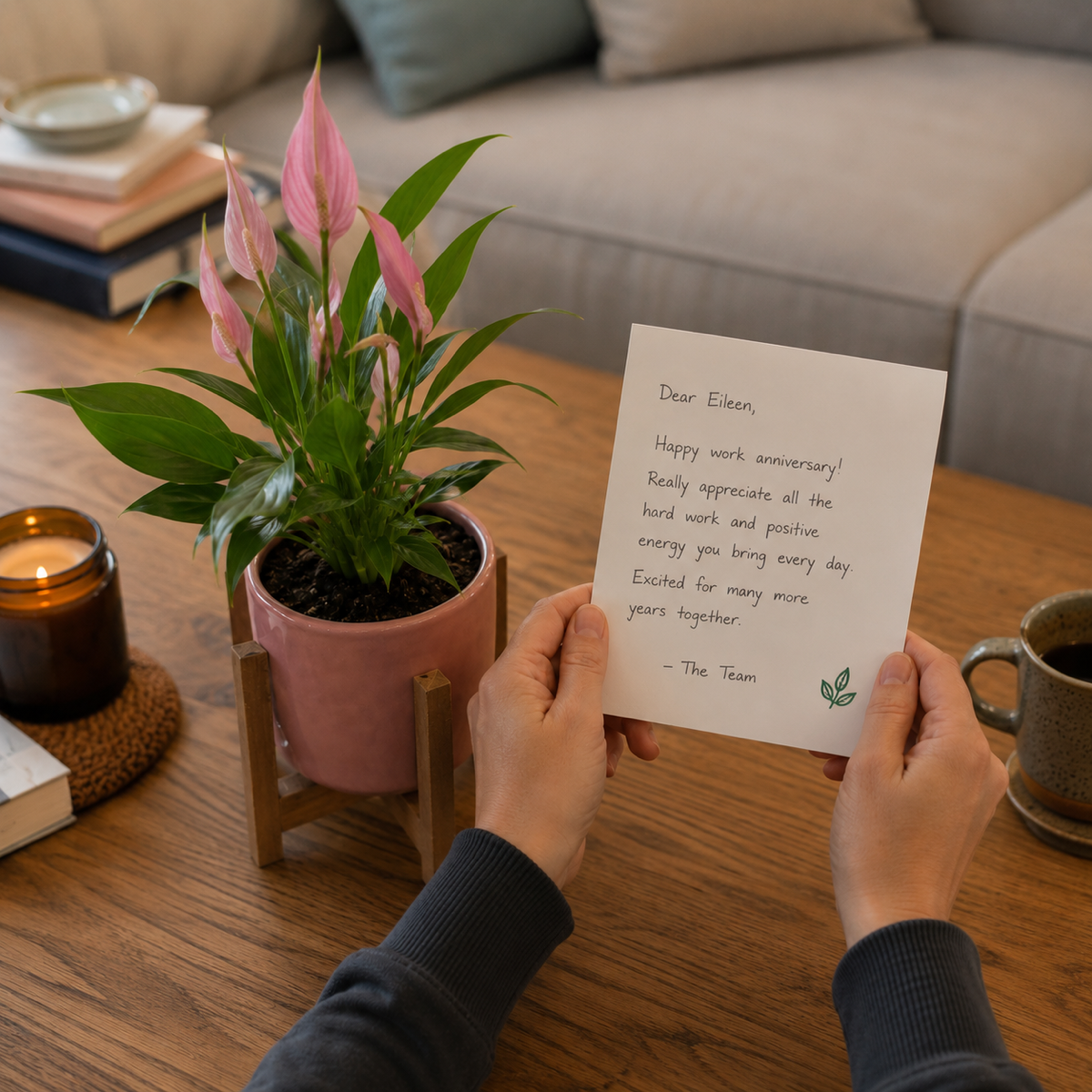 Pink peace lily in a box with a handwritten 'Happy work anniversary' card